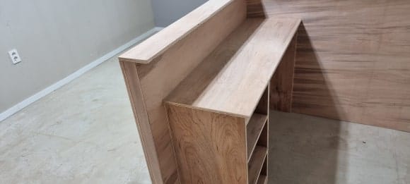 맞춤 카운터 안쪽의 넓힌 상판과 양쪽 수납칸, 중앙 의자 공간을 확인할 수 있는 목공 작업 완료 모습.