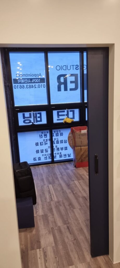 사진 10. 매장 안쪽에서 입구 방향을 바라본 모습으로, 벽 안쪽으로 이동해 출입구를 열어 두는 슬라이딩 도어 구조가 보입니다.